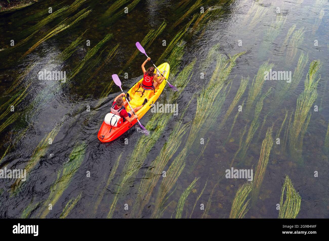 Canoeists canoeing down the Ariege River in the French Pyrenees, South of France. Stock Photo