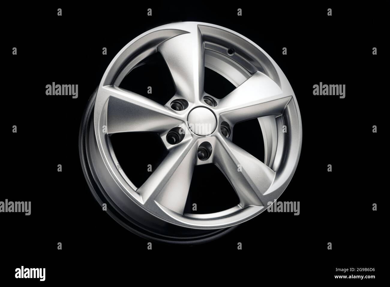 car alloy wheel, new five-spoke silver on a black background, auto ...