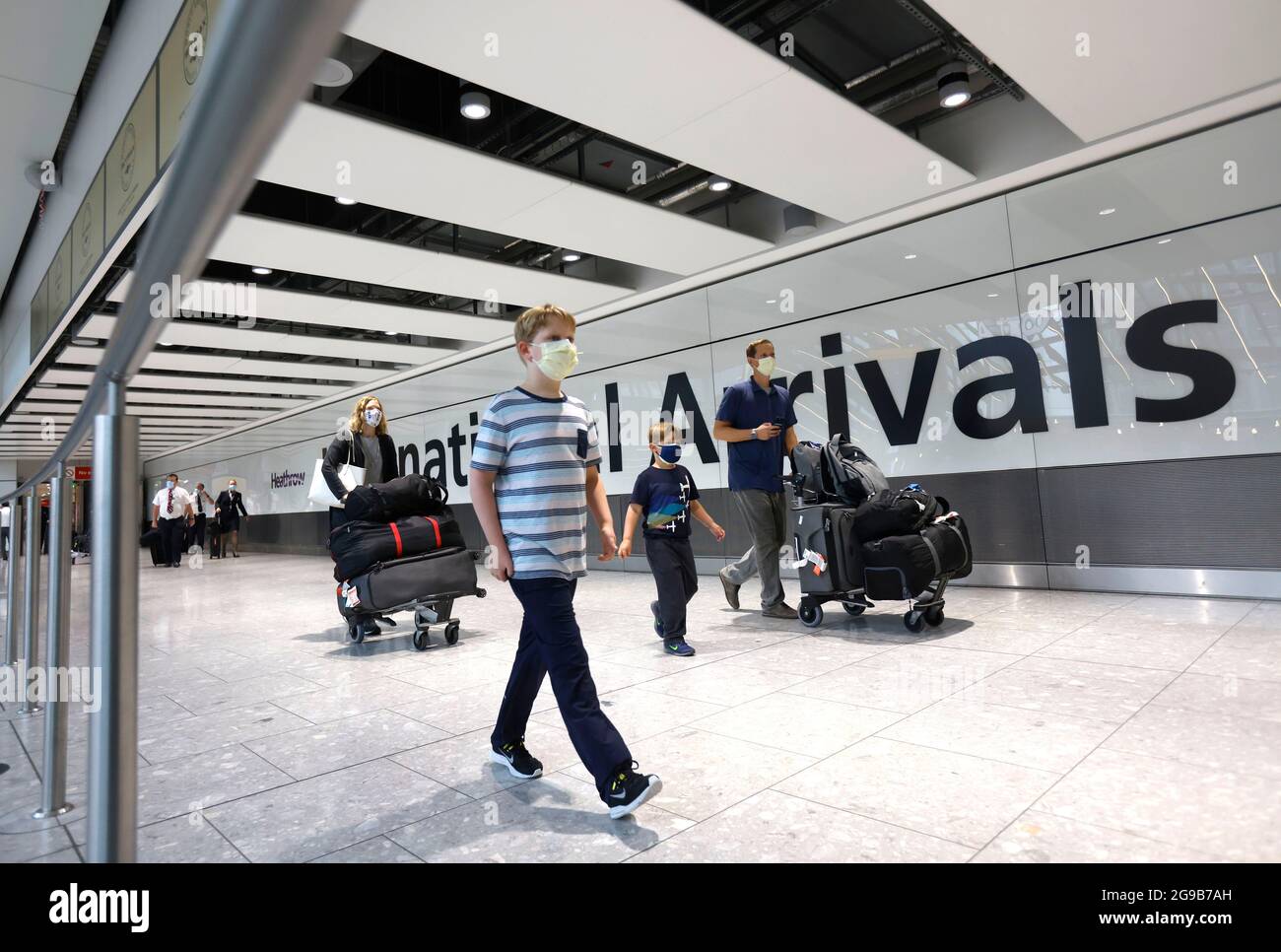 London, UK. 25th July, 2021. Passengers arriving at Terminal 5. Passengers departing and arriving at Heathrow airport as the holiday season starts. The traffic light system is in place with different rules for Green, Amber and Red list countries. Some passengers will have to self isolate on arrival. Credit: Mark Thomas/Alamy Live News Stock Photo