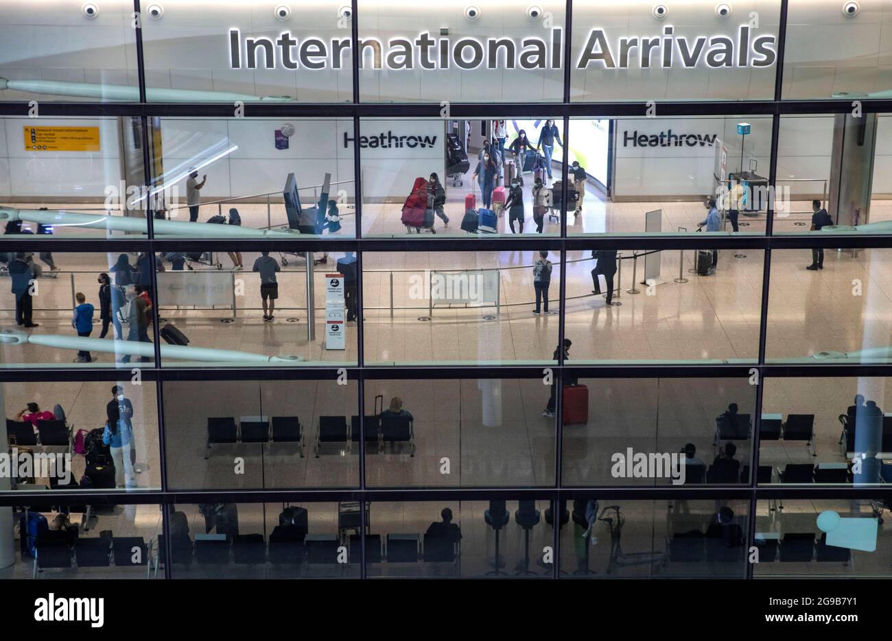 London, UK. 25th July, 2021. Arrivals at Terminal 2. Passengers departing and arriving at Heathrow airport as the holiday season starts. The traffic light system is in place with different rules for Green, Amber and Red list countries. Some passengers will have to self isolate on arrival. Credit: Mark Thomas/Alamy Live News Stock Photo