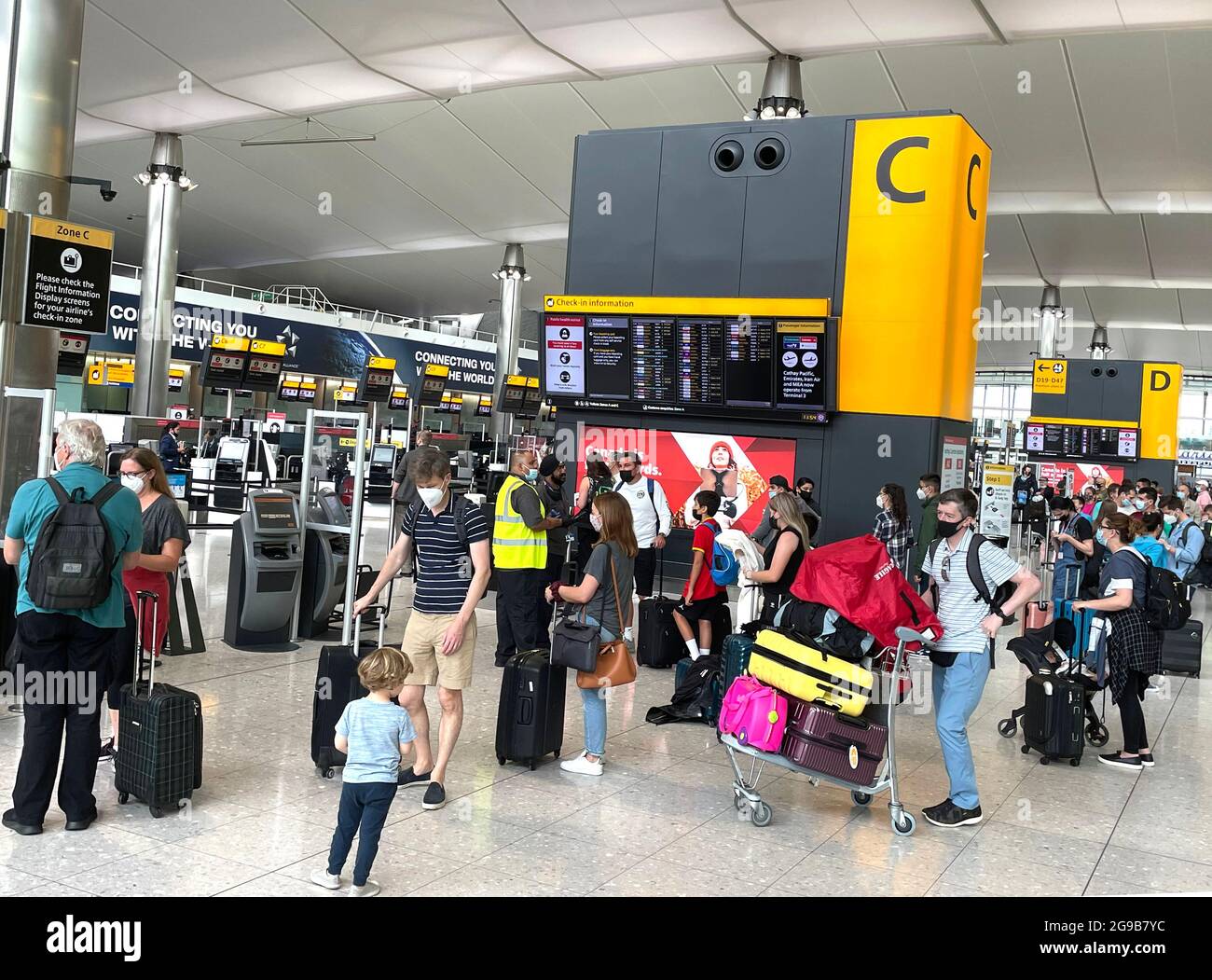 London, UK. 25th July, 2021. Departures at Terminal 5. Passengers departing and arriving at Heathrow airport as the holiday season starts. The traffic light system is in place with different rules for Green, Amber and Red list countries. Some passengers will have to self isolate on arrival. Credit: Mark Thomas/Alamy Live News Stock Photo