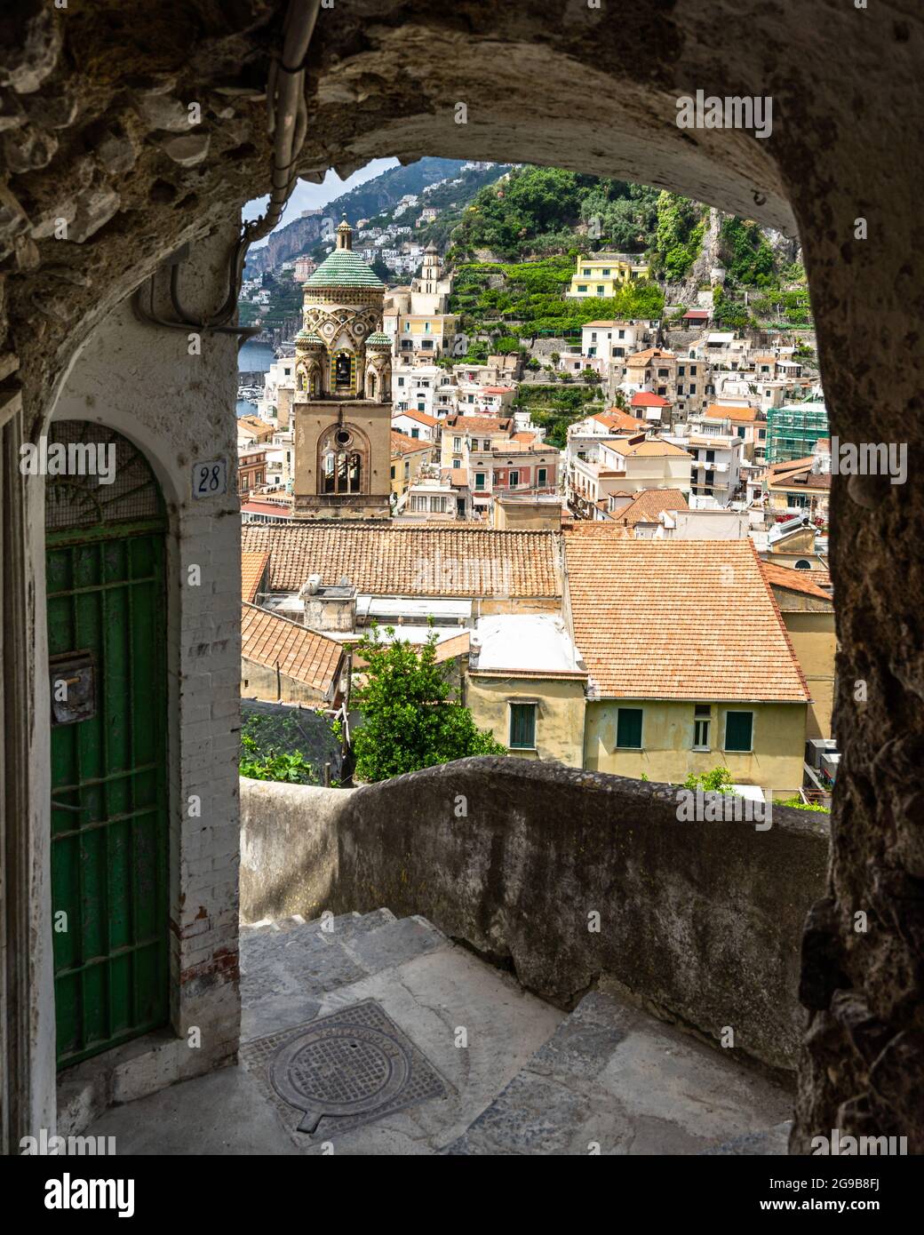 Amalfi with the cathedral's bell tower seen from a steep stairway climbing up the hill, Italy Stock Photo