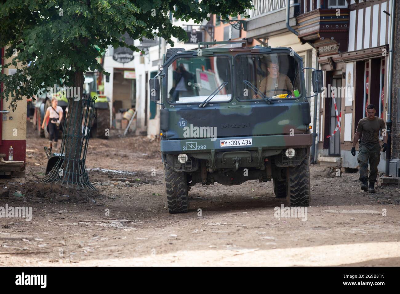 24 July 2021, North Rhine-Westphalia, Bad Münstereifel: A Bundeswehr vehicle drives through a badly damaged road. After last week's flood disaster, clean-up work is underway in the affected regions of western Germany. Photo: Thomas Banneyer/dpa Stock Photo