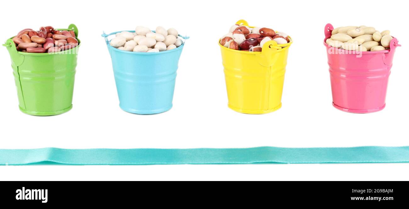 Different types of beans in colored buckets isolated on white Stock
