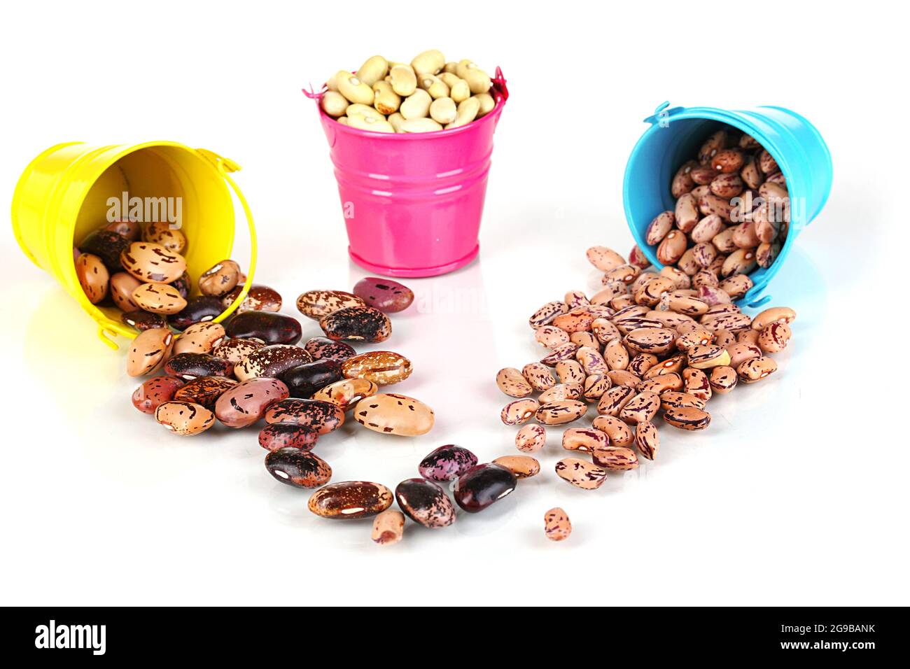 Different types of beans in colored buckets isolated on white Stock