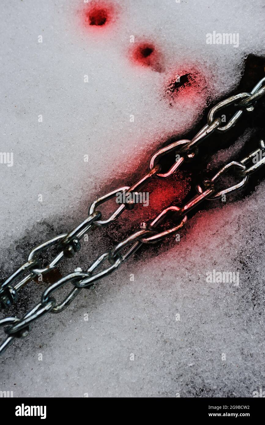 Silver chain with blood on snow Stock Photo