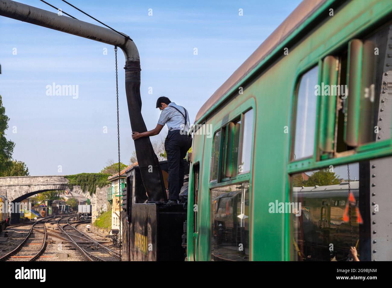 Refueling a steam train at Swanage train depot Dorset, England UK