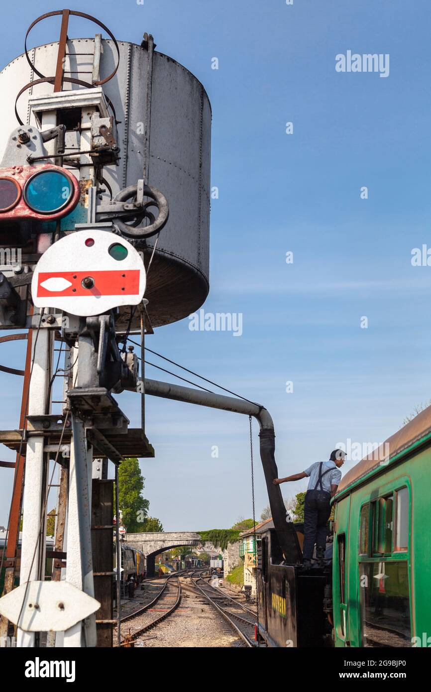 Refueling a steam train at Swanage train depot Dorset, England UK