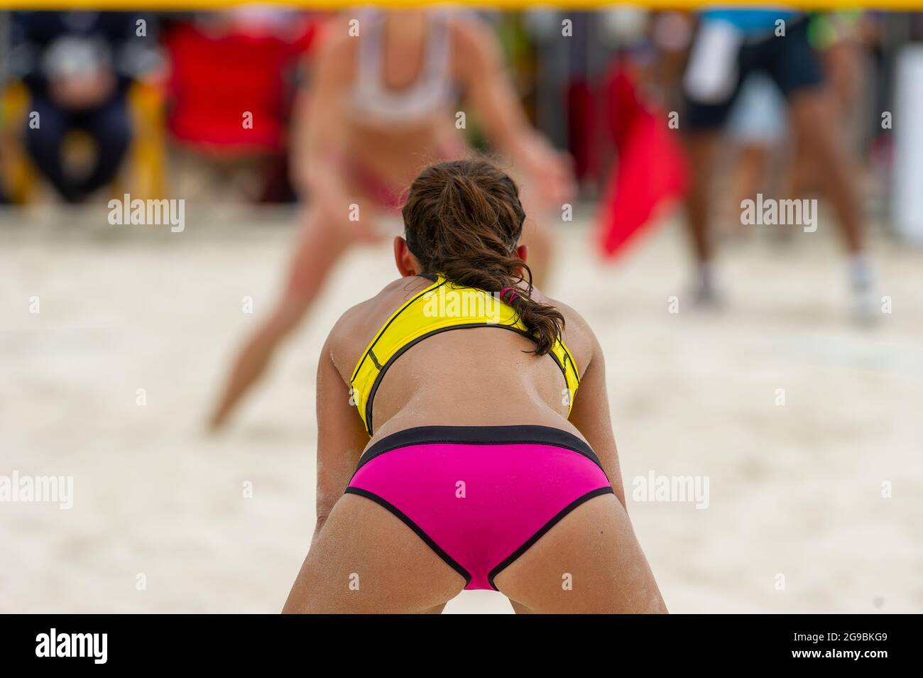 A Female Beach Volleyball Player Is Getting Ready To Serve The Ball