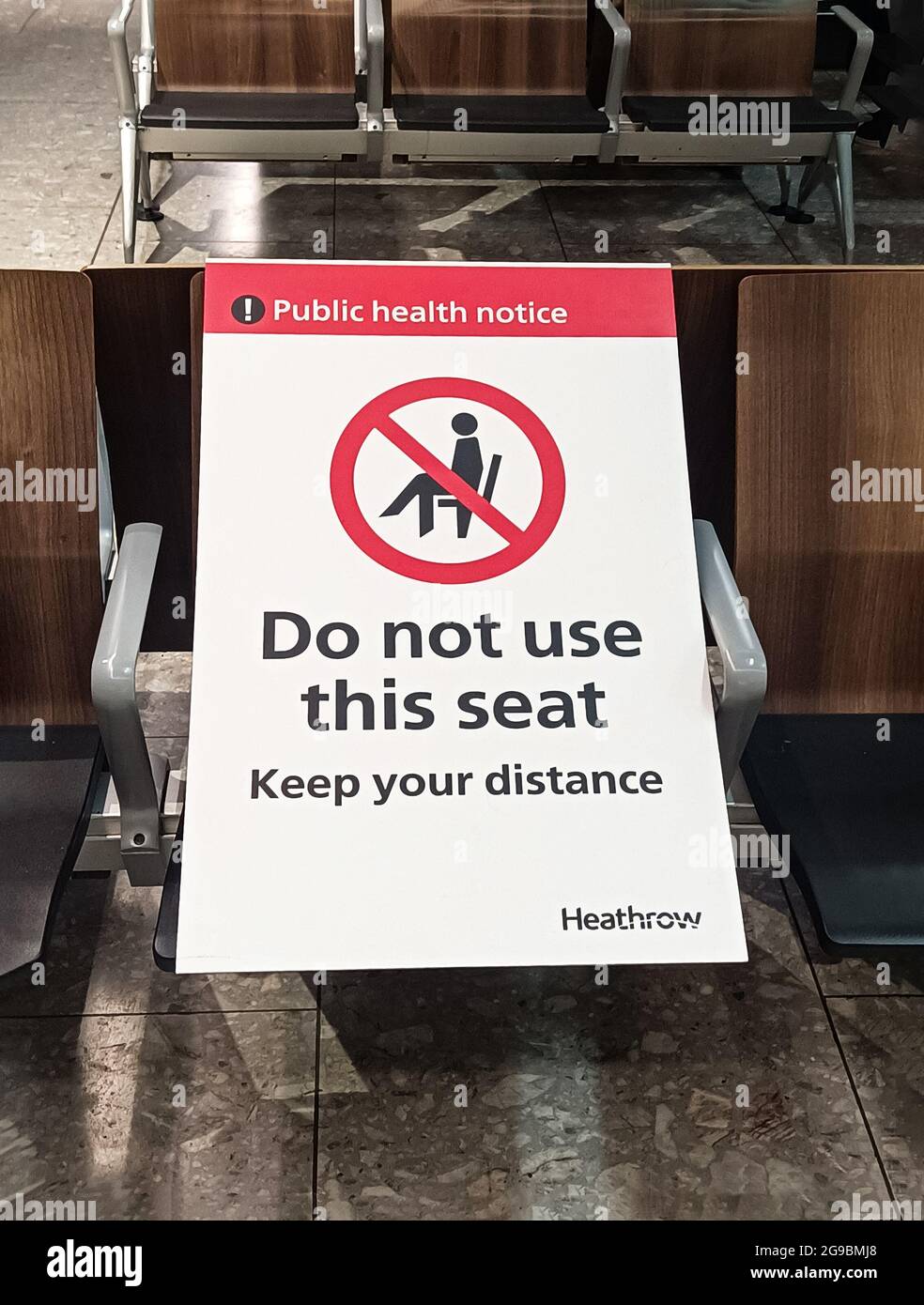 London, England, 15 March 2021. Departures at Heathrow International Airport with side signs warning passengers to keep their distance due to the COVI Stock Photo
