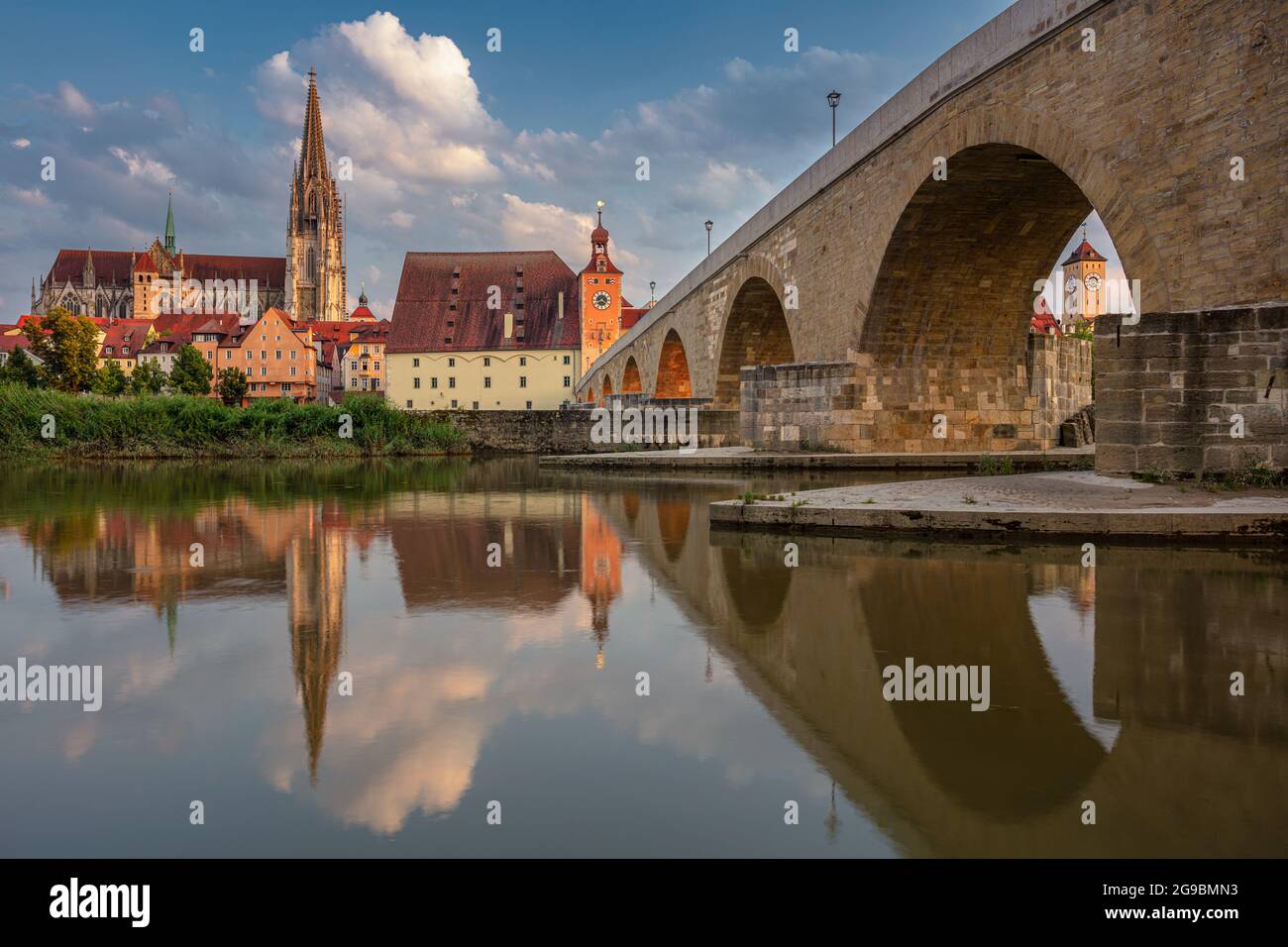 Regensburg, Germany. Cityscape image of Regensburg, Germany with Old Stone Bridge over Danube River and St. Peter Cathedral at summer sunset. Stock Photo