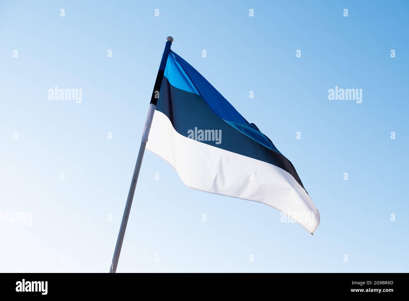 Flag of Estonia on blue sky background. Estonian flag waving in wind ...