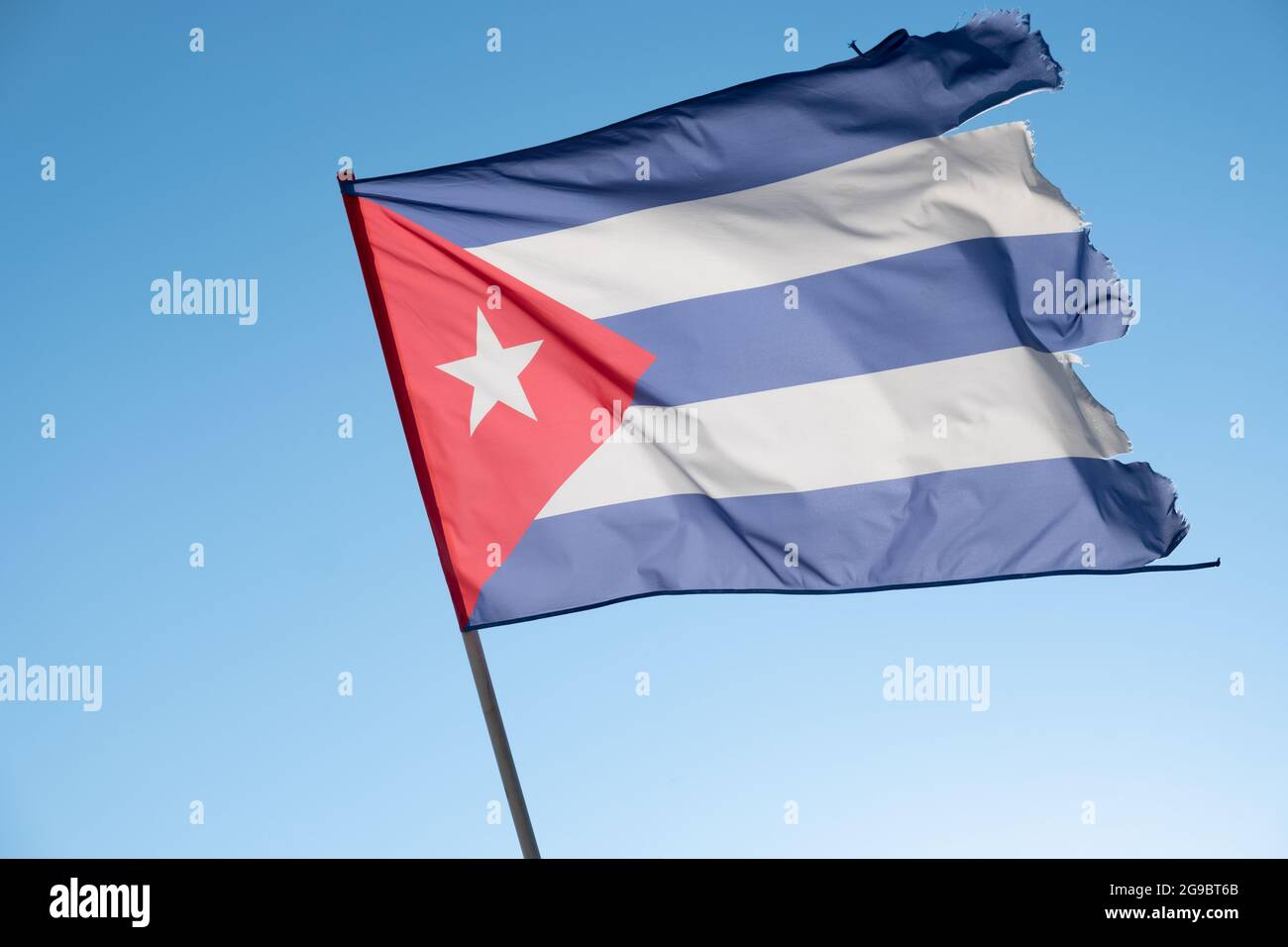 Flag of Cuba on blue sky background. Empty copy space. Cuban flag waving in wind Stock Photo