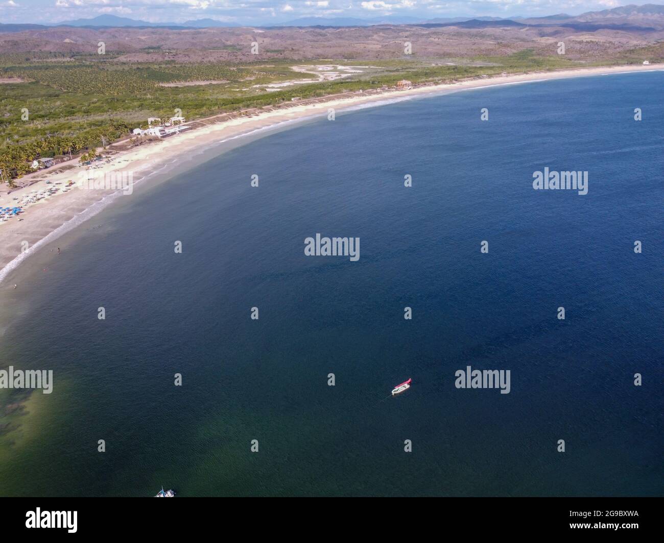 A stunning aerial view of a sandy beach and calm sea on a sunny summer ...