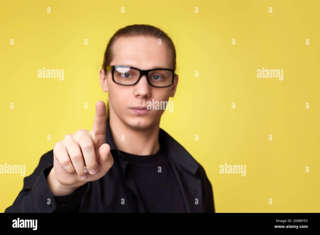 young man in glasses touching virtual screen Stock Photo