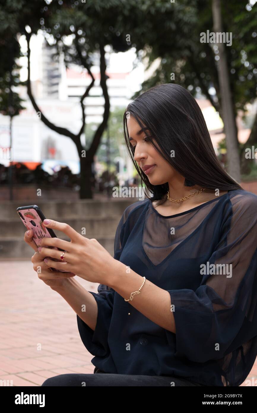 latin woman using a smartphone Stock Photo
