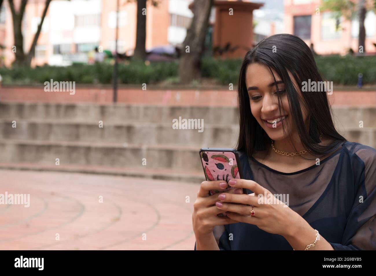 latin woman using a smartphone Stock Photo