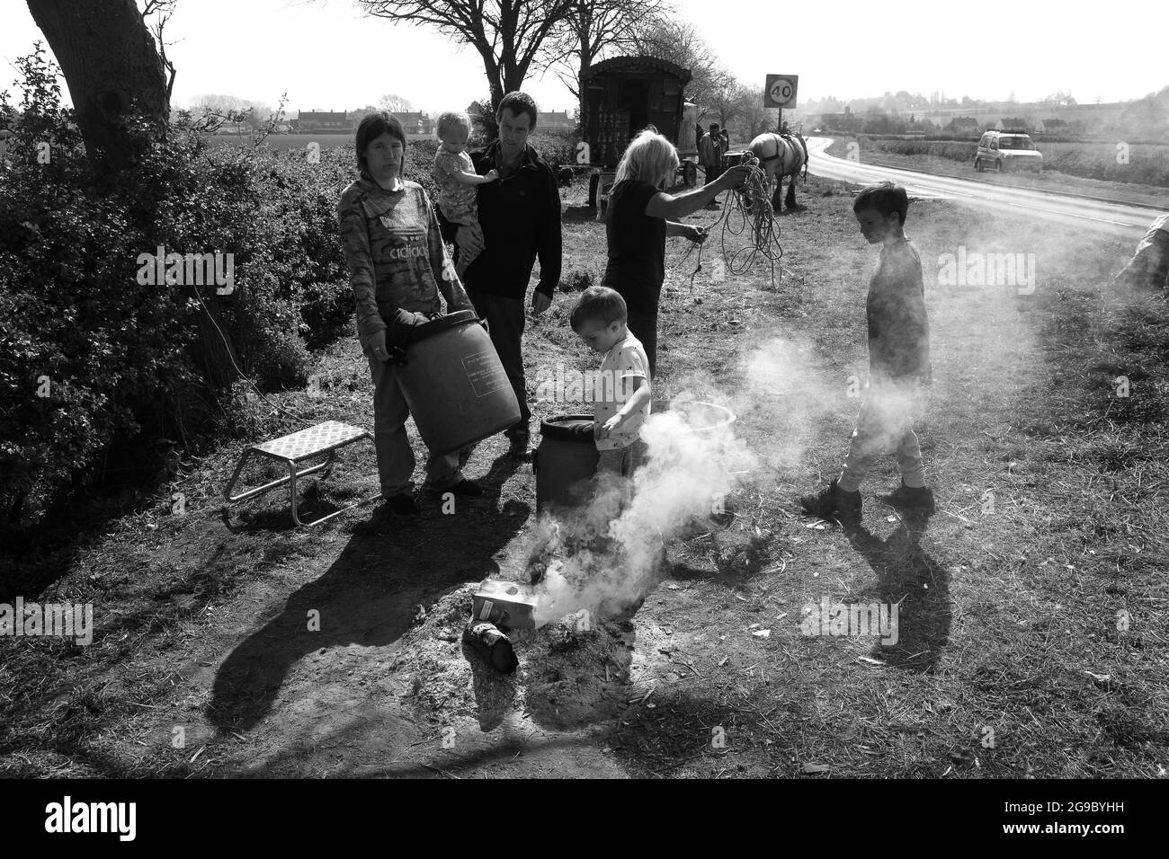 Romany family cleaning up the site as they prepare to move on at Sutton Maddock in Shropshire England Uk. Percy Bennett and family Stock Photo