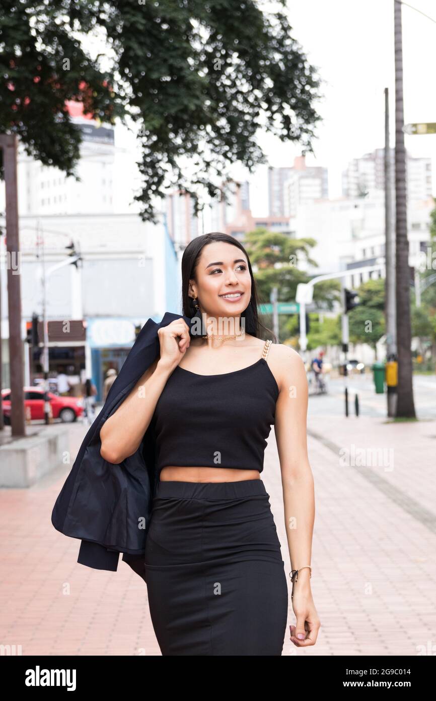 latin business woman walks around the city Stock Photo - Alamy