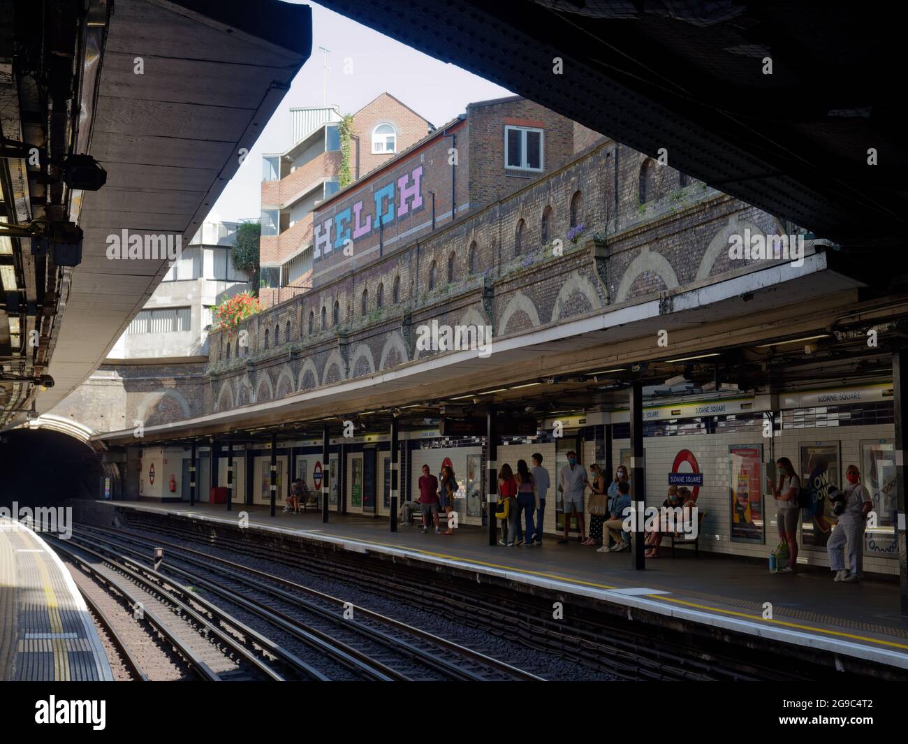 London, Greater London, England, June 12 2021: People waiting on a platform at Sloane Square underground Station or Tube Station. Stock Photo