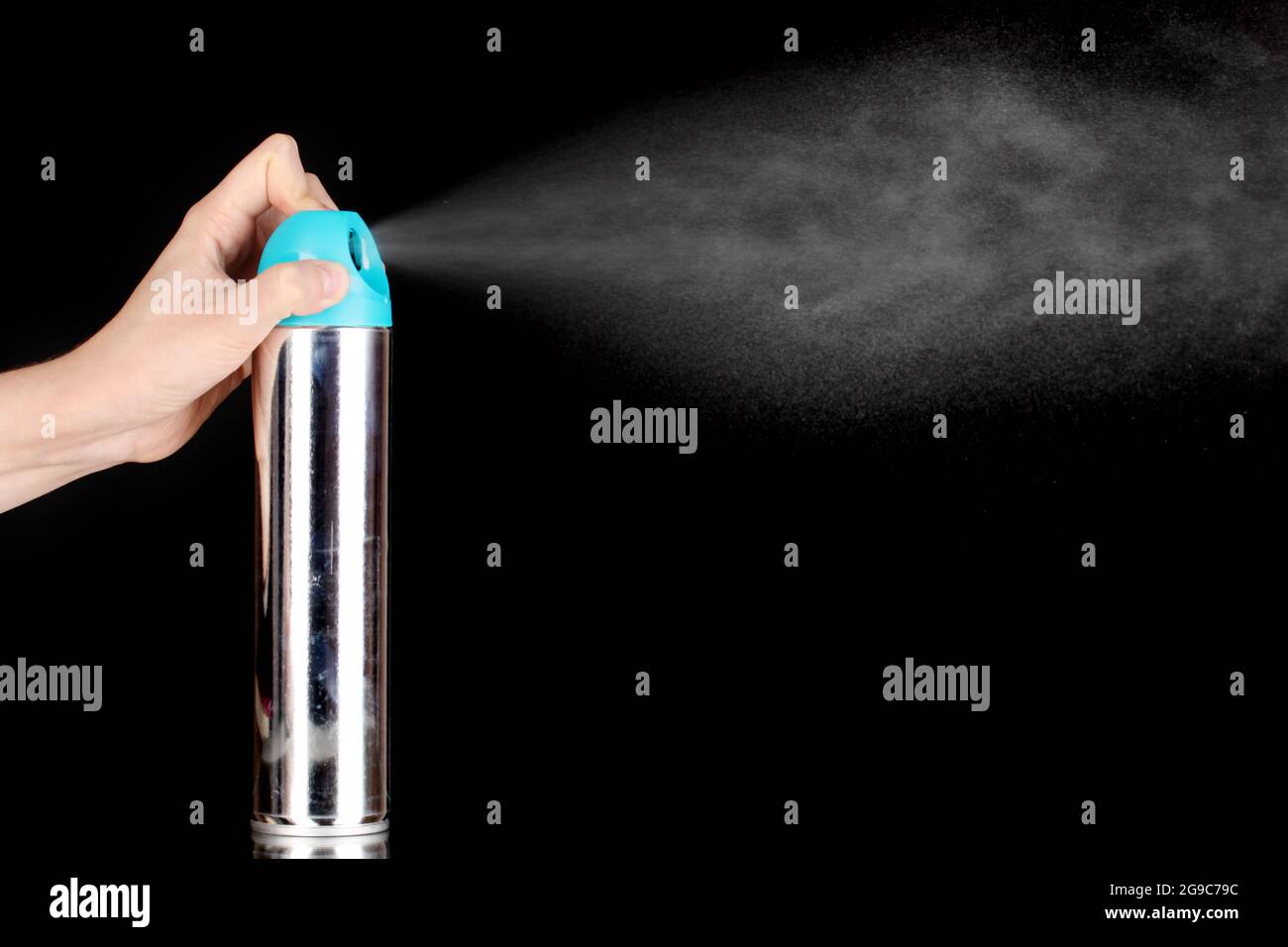 Sprayed air freshener in hand isolated on black Stock Photo Alamy