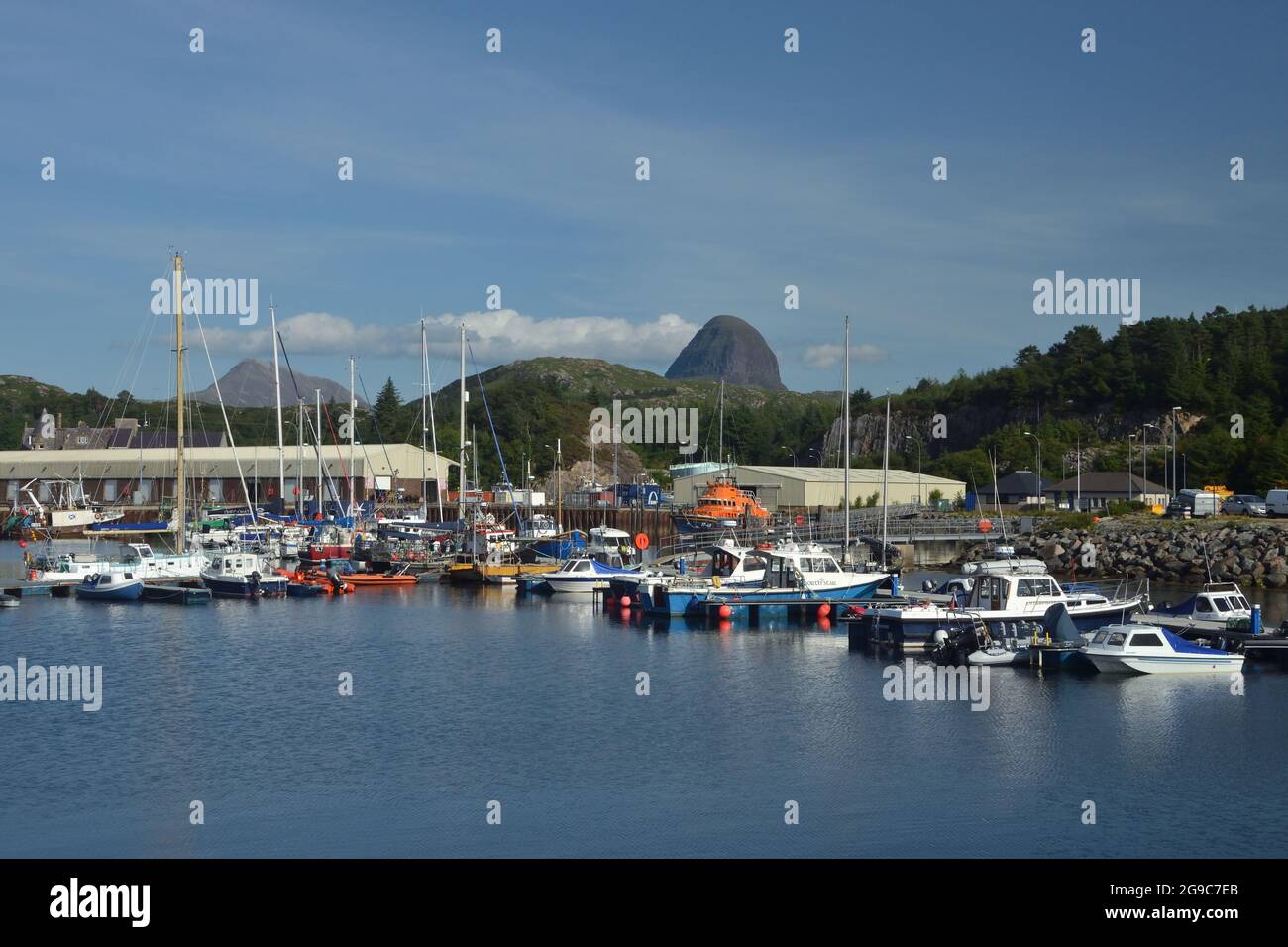 The marina at Lochinver Harbour, with the mountain Suilven visible in the background. At Lochinver, Scottish Highlands, UK. Stock Photo