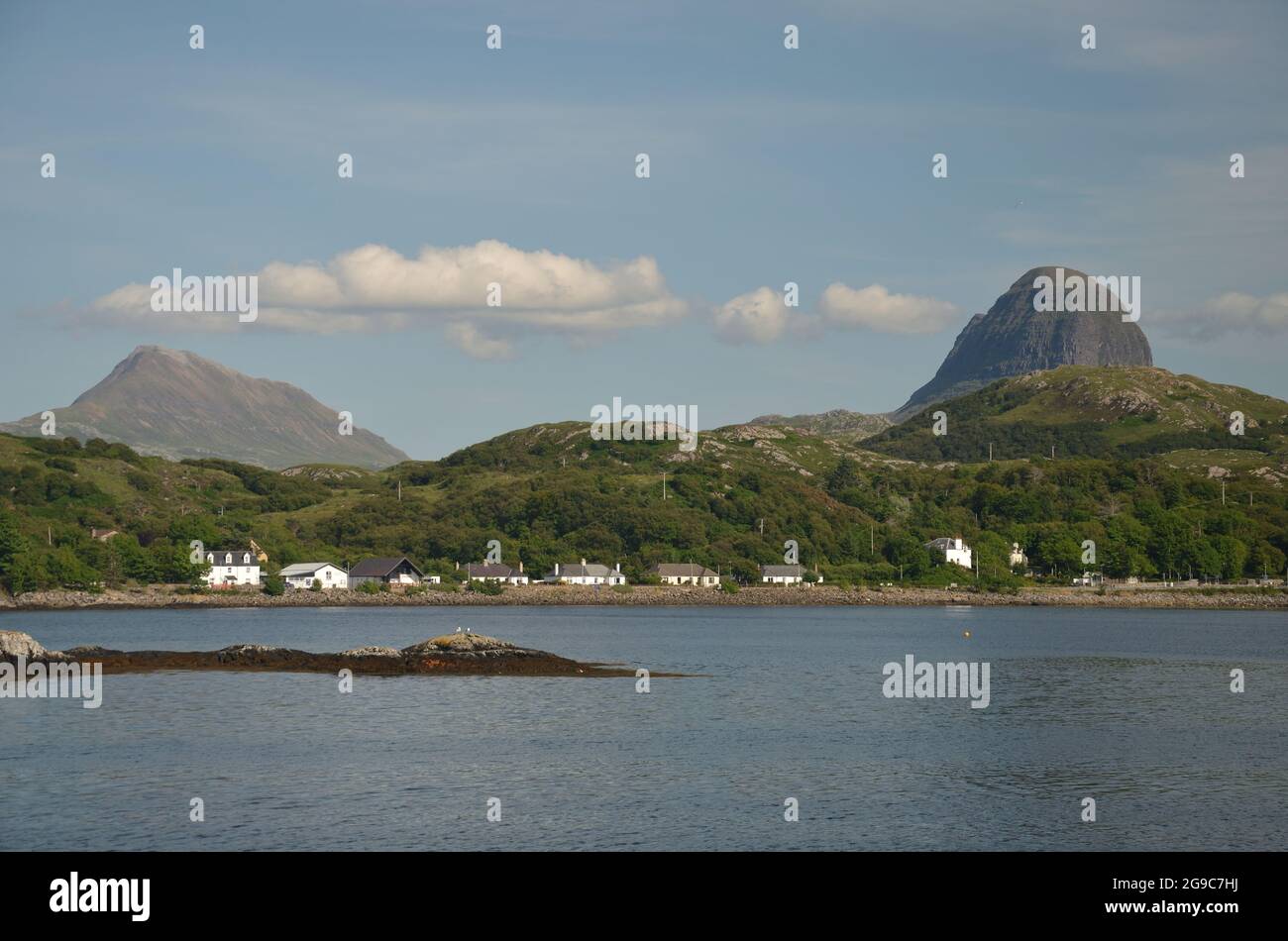 The small coastal settlement of Lochinver, Scottish Highlands, with the hills Canisp (left) and Suilven (right) behind.  A destination on the NC500. Stock Photo