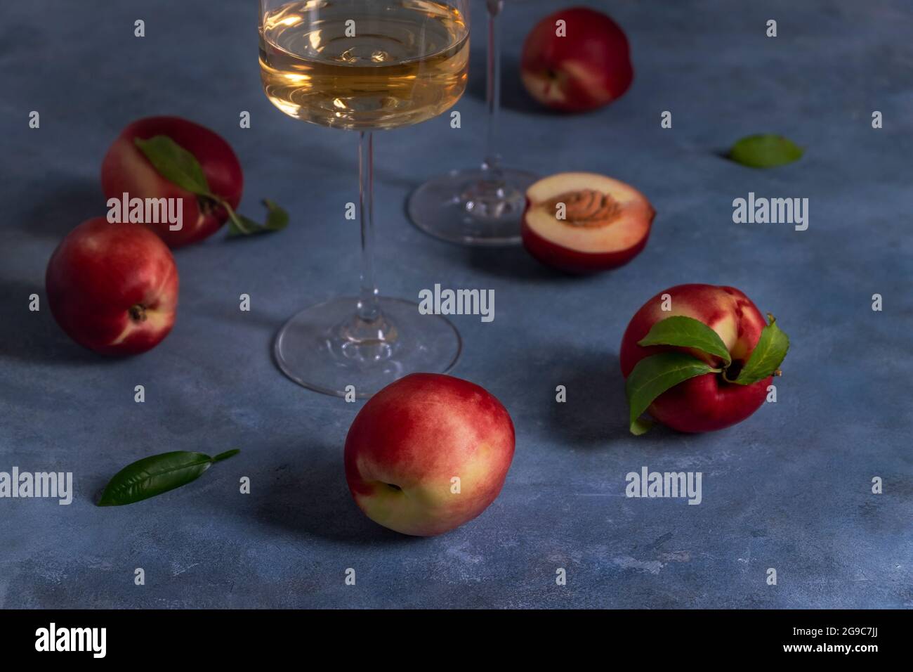 Peaches or nectarines and a glass of wine Stock Photo