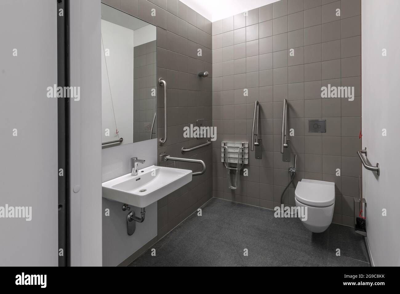 Public restroom for disabled handicapped people with special equipment