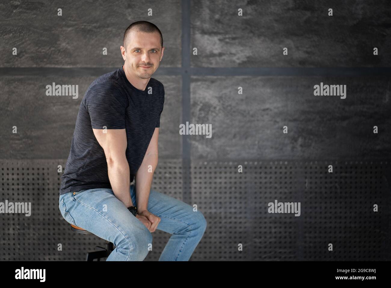 Young handsome man smiling and looking at camera Stock Photo - Alamy