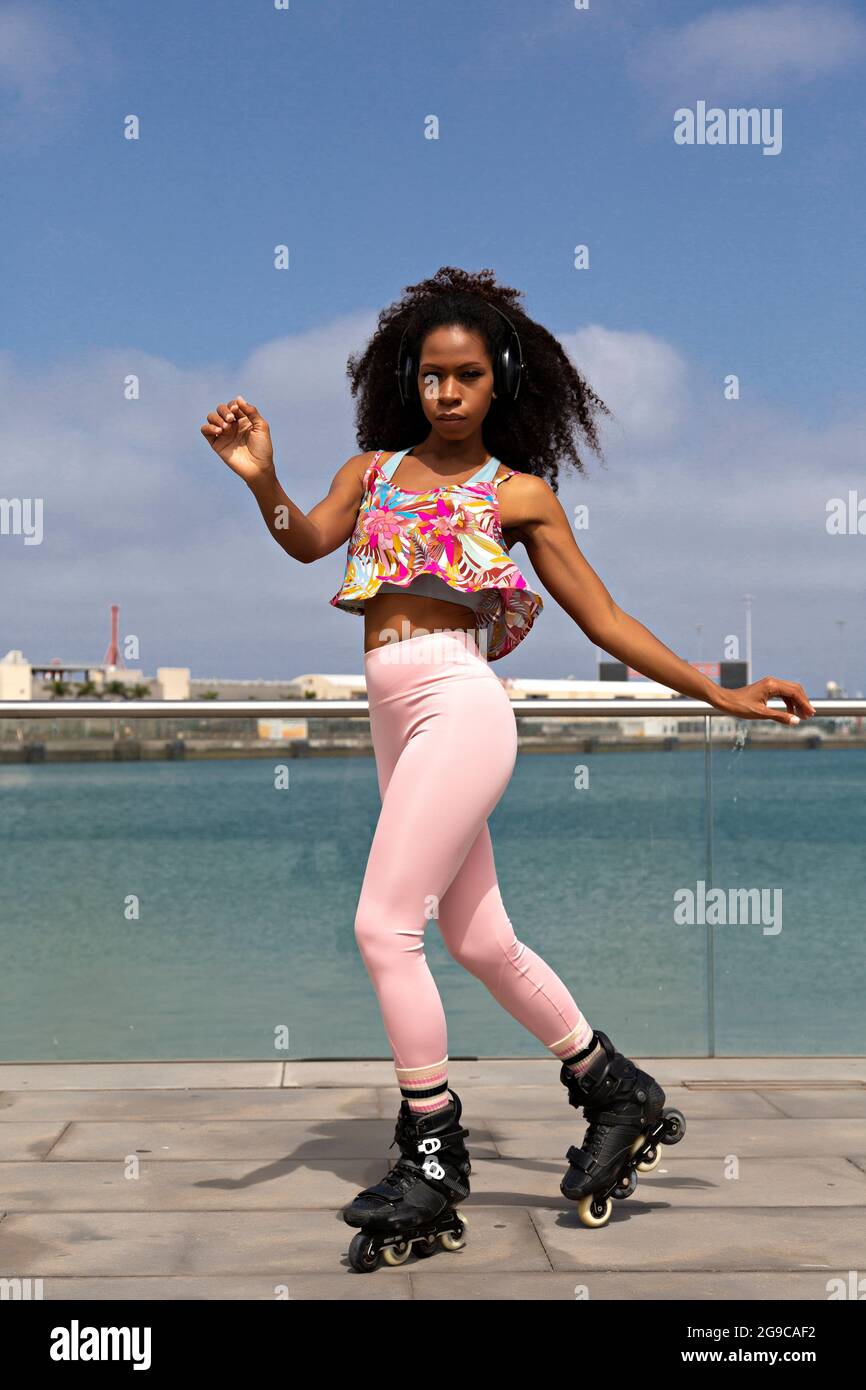 Afro Caribbean woman dancing on roller skates with lots of rhythm Stock Photo
