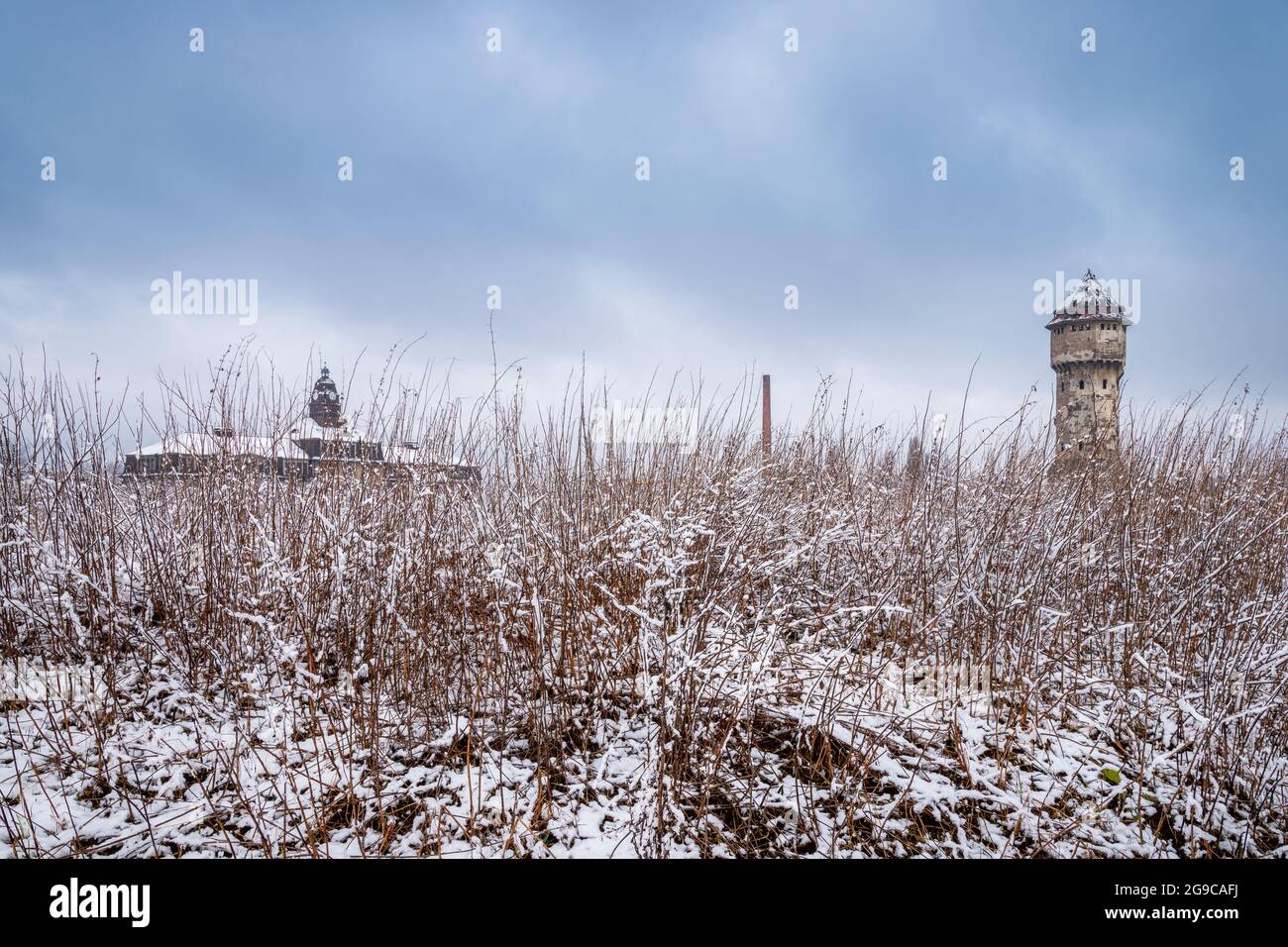 Winter view on an abandoned, 19th-century ironworks building and water tower, Katowice, Silesia, Poland Stock Photo