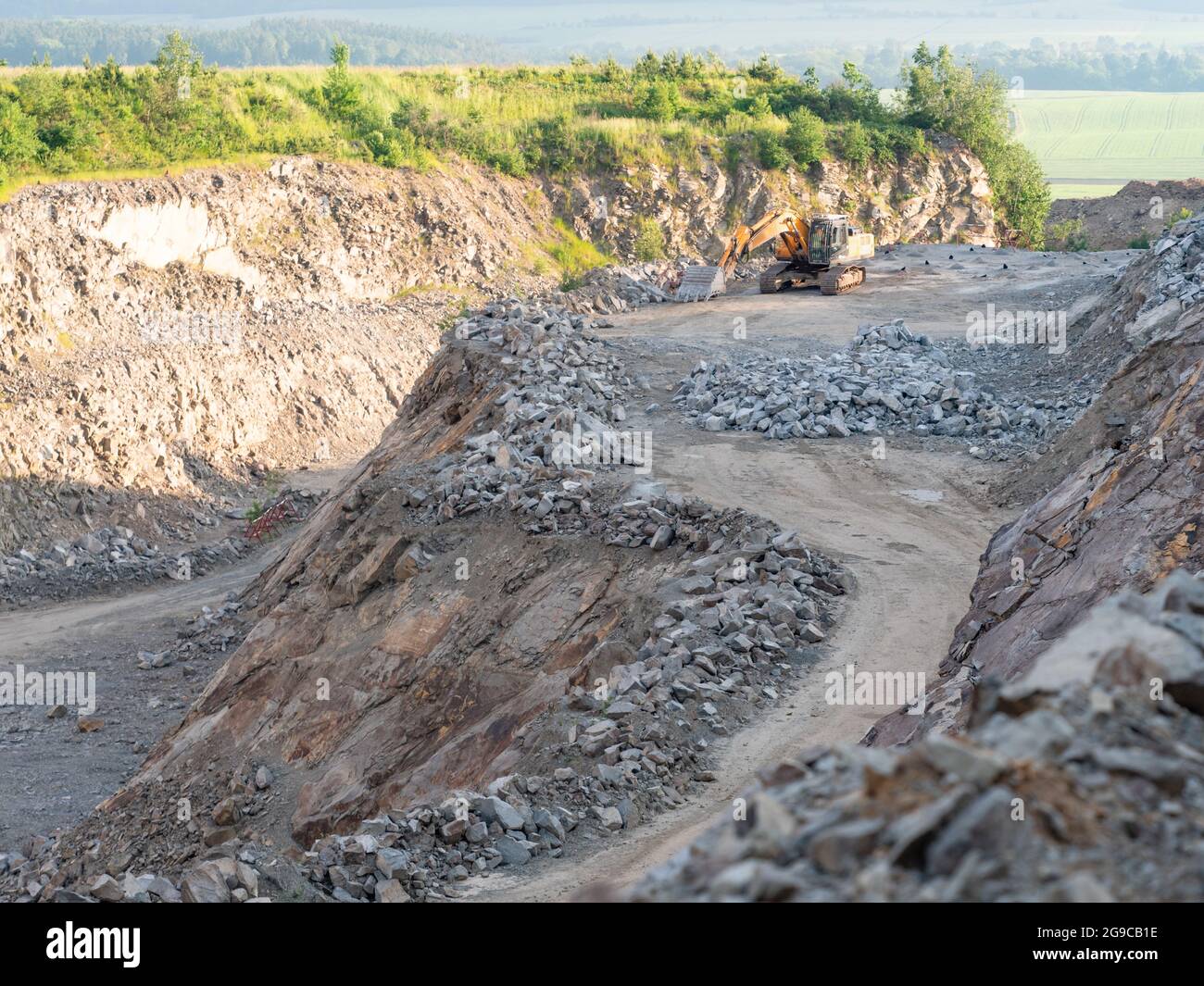 Industrial track type excavator digging at a quarry site, heavy ...