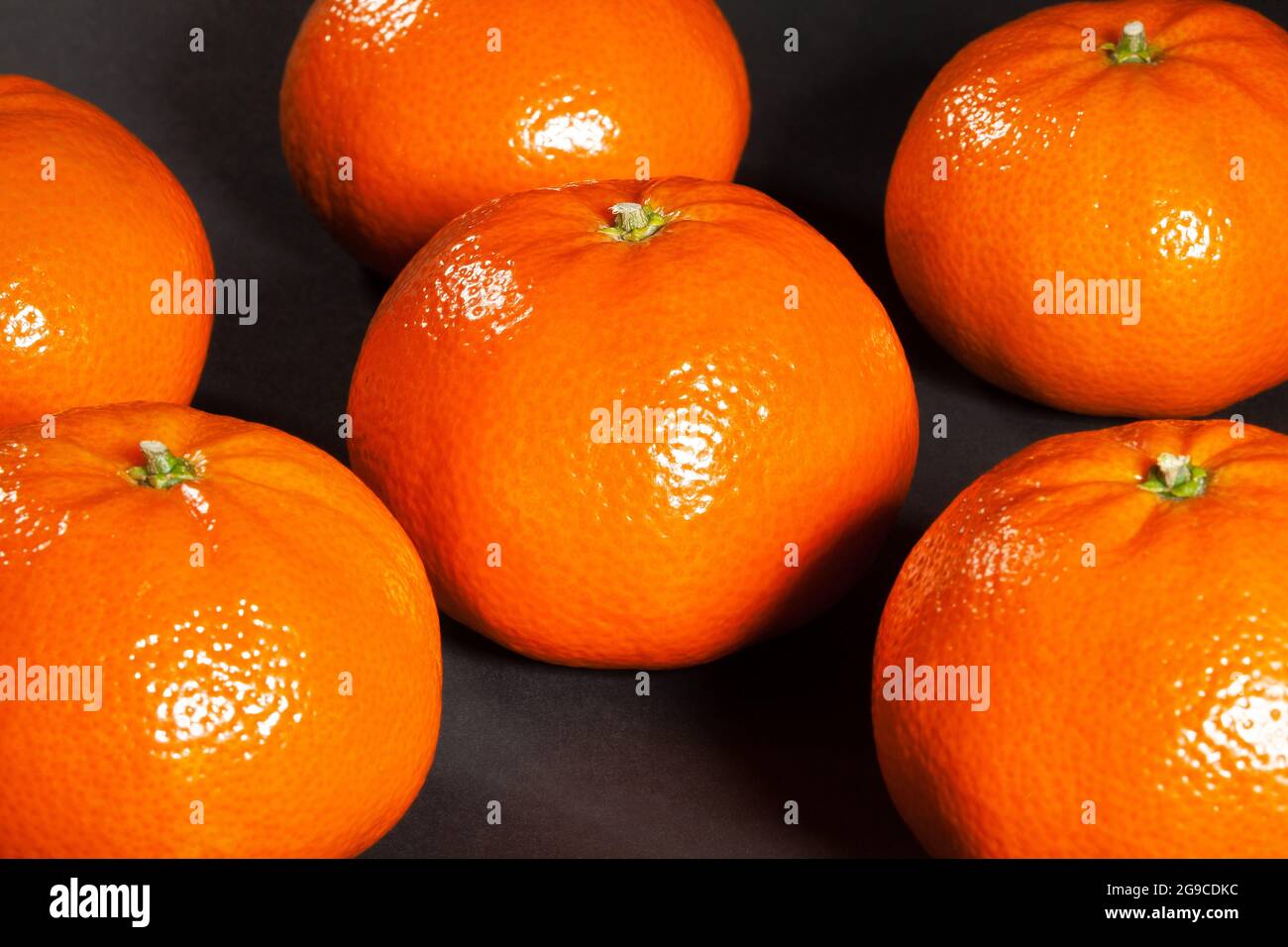 large tangerine group on black background Stock Photo Alamy