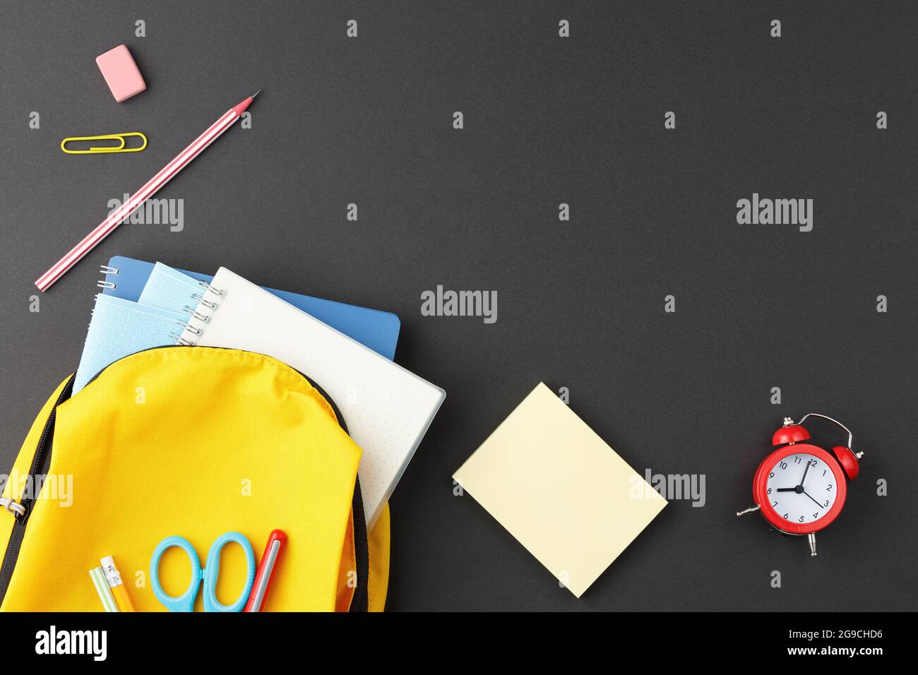 School supplies in a yellow backpack. Stock Photo