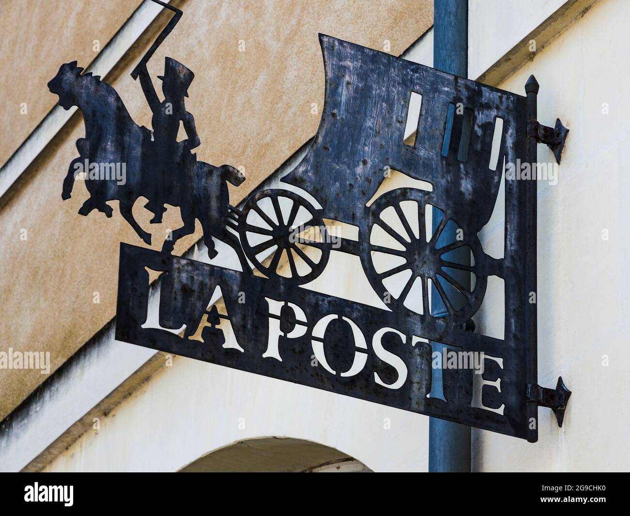 Mail coach 'La Poste' metal sign outside the post office in Richelieu, Indre-et-Loire, France. Stock Photo