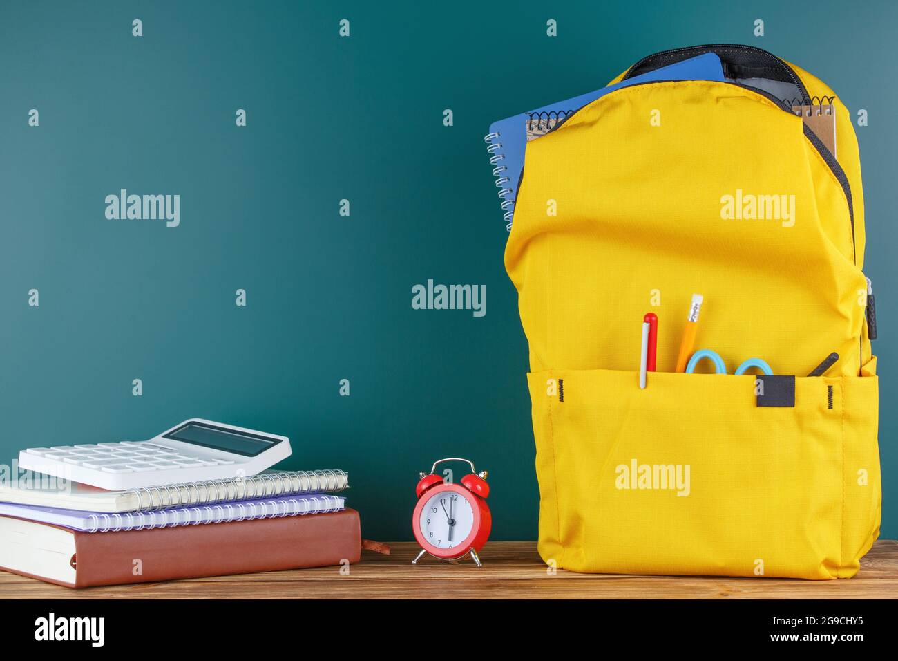 Backpack on the desk in the classroom. Stock Photo