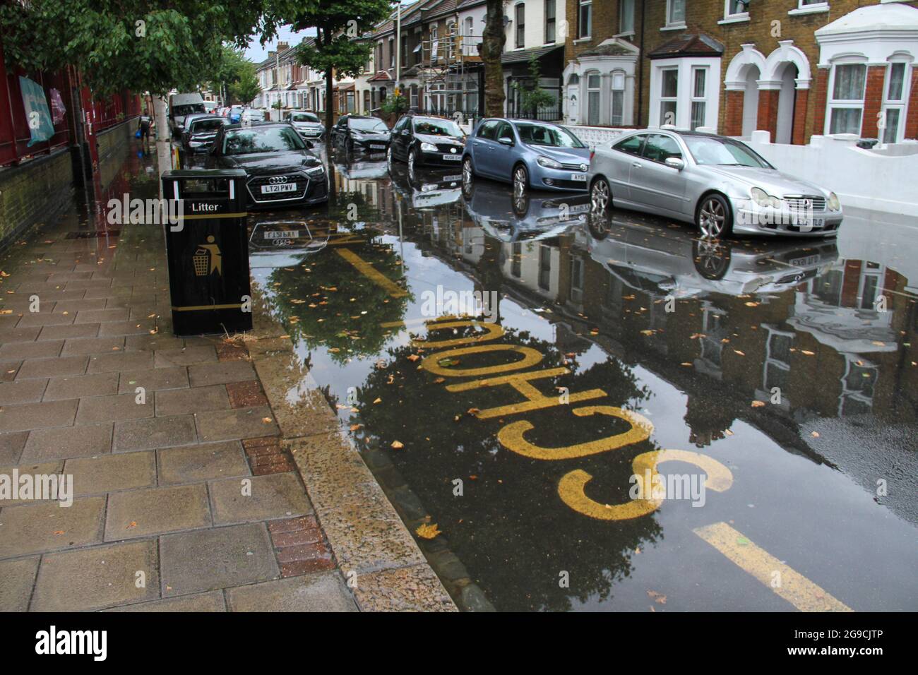 Vehicles seen parked on a flooded street in a suburb in East London following flash flooding ?today afternoon.? Extreme heat in the previous week has given way to cooler temperatures and stormy weather in England.? ?An amber thunderstorm warning is in place for much of south-east England?.? Stock Photo