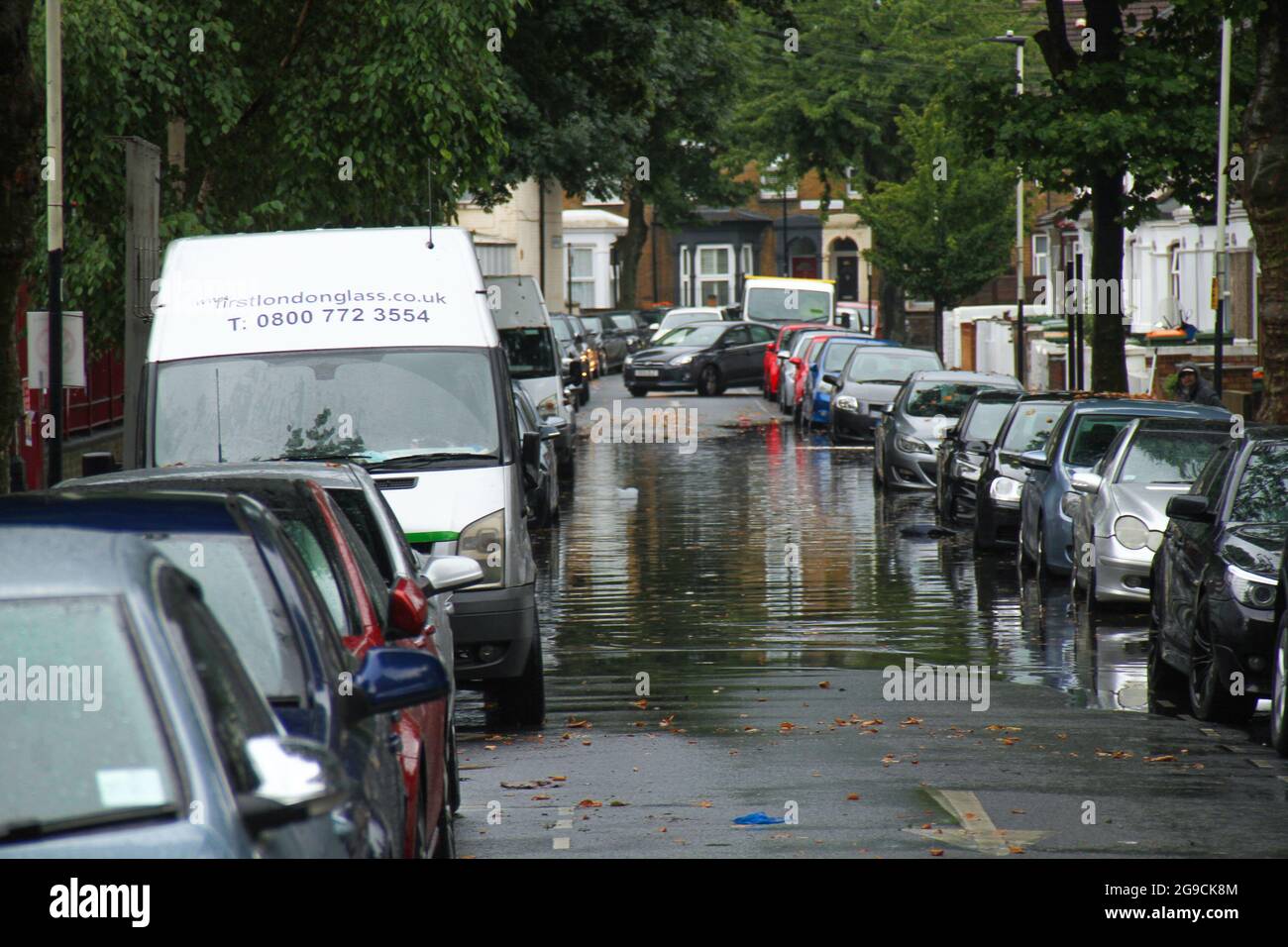 London, UK. 25th July, 2021. Vehicles seen parked on a flooded street in a suburb in East London following flash flooding ?today afternoon.? Extreme heat in the previous week has given way to cooler temperatures and stormy weather in England.? ?An amber thunderstorm warning is in place for much of south-east England?.? (Photo by David Mbiyu/SOPA Images/Sipa USA) Credit: Sipa USA/Alamy Live News Stock Photo