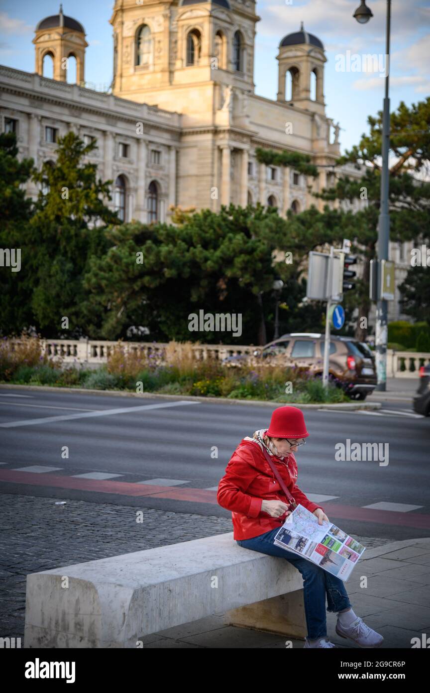 Vienna Austria - September 26, 2019. Women sitting on the road side reading map of Vienna city. Stock Photo