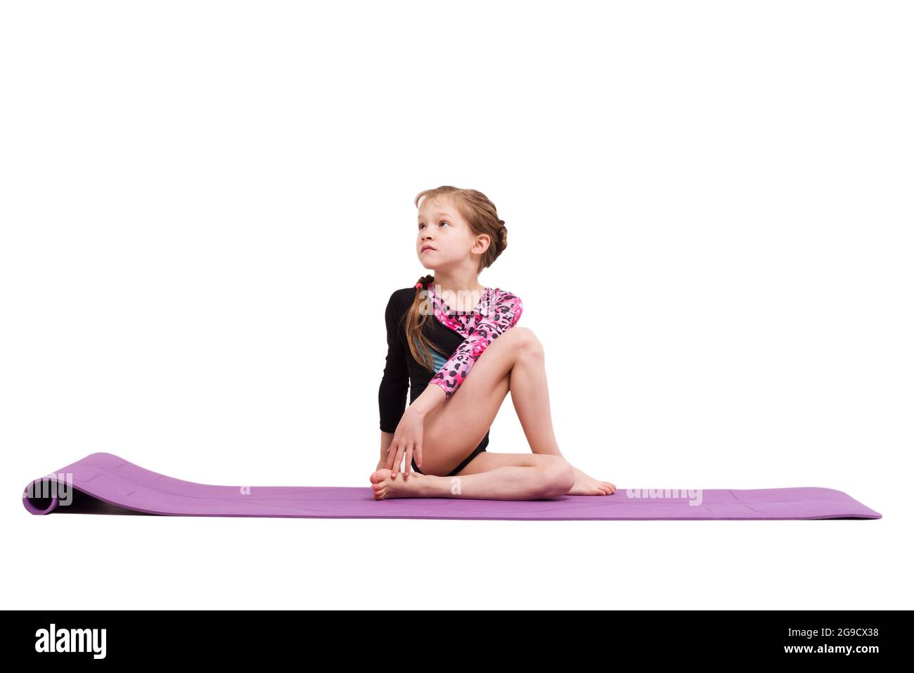 Cute child girl making Gymnastic exercises against white. Stock Photo