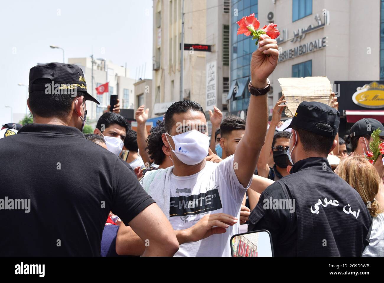 Tunis, Tunisia. 25th July, 2021. A protester holding flowers during a rally against Ennahdha party and the government at the Parliament.Supreme Council for Youth called for protests on Republic Day demanding a change in the political system during a transitional period of 6 months while retaining the President of the Republic, Qais Saied. (Photo by Jdidi Wassim/SOPA Images/Sipa USA) Credit: Sipa USA/Alamy Live News Stock Photo