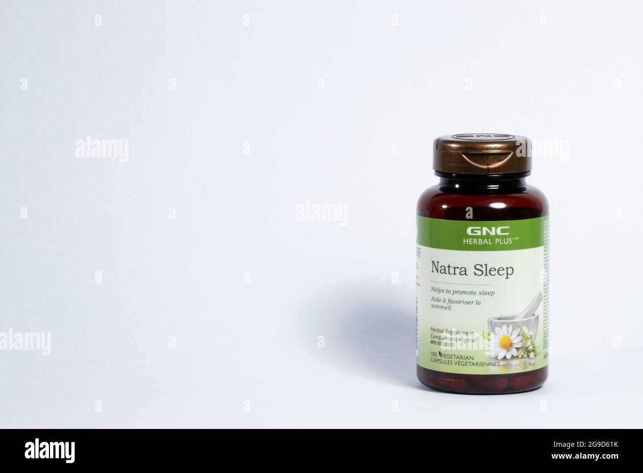 GNC herbal sleep aid pills are in a plastic bottle isolated on a white background with space for text writing. Stock Photo