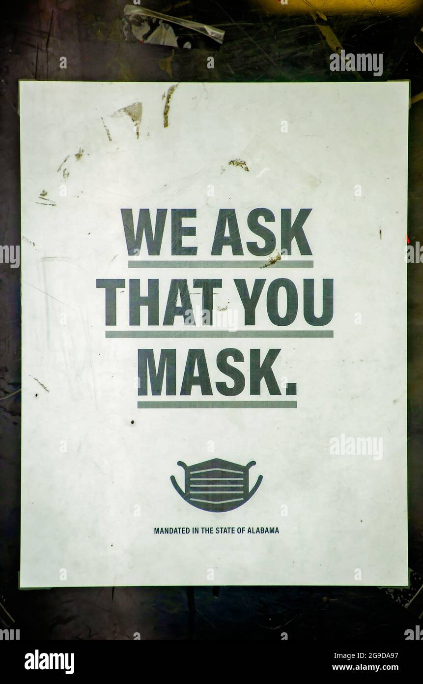 A sign asks customers to wear masks in the store to prevent the spread of COVID-19, July 23, 2021, in Mobile, Alabama. Stock Photo