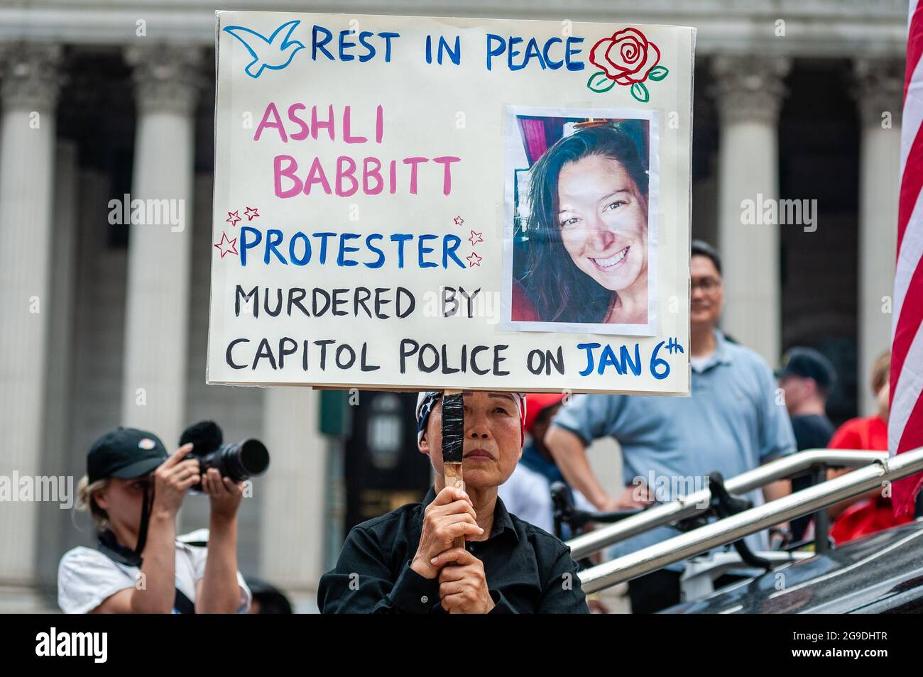 A woman holds a sign with the image of Ashli Babbitt, who was shot by police while storming the U.S. Capitol, at a far right rally in Foley Square in New York City on July 25, 2021. The rally, organized by C.A.P.P., called for the release of rioters, who were arrested after storming the U.S. Capitol on January 6, 2021. (Photo by Gabriele Holtermann/Sipa USA) Credit: Sipa USA/Alamy Live News Stock Photo