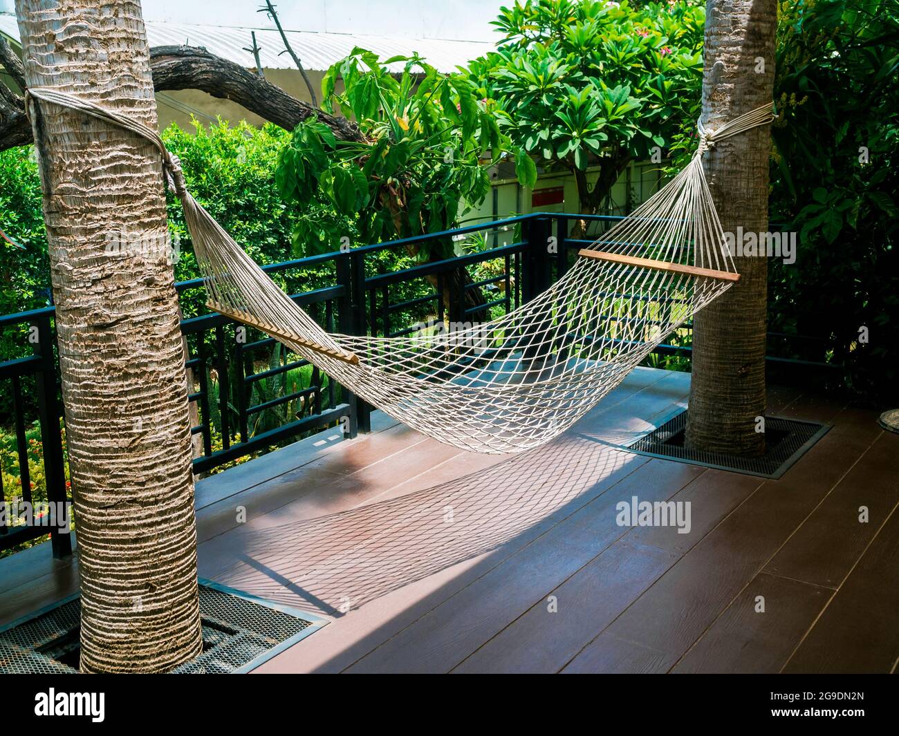 Empty white cotton rope cradle. Swing hammock hanging between two