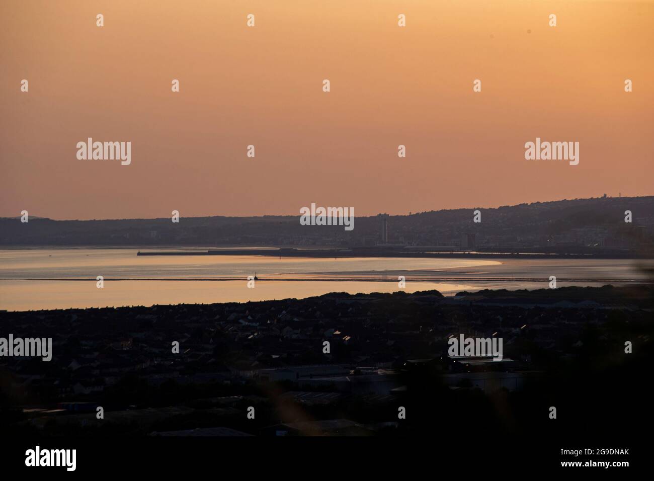 A view towards Swansea from Port Talbot, South Wales during sunset on the 20th July 2021. Credit: Lewis Mitchell Stock Photo