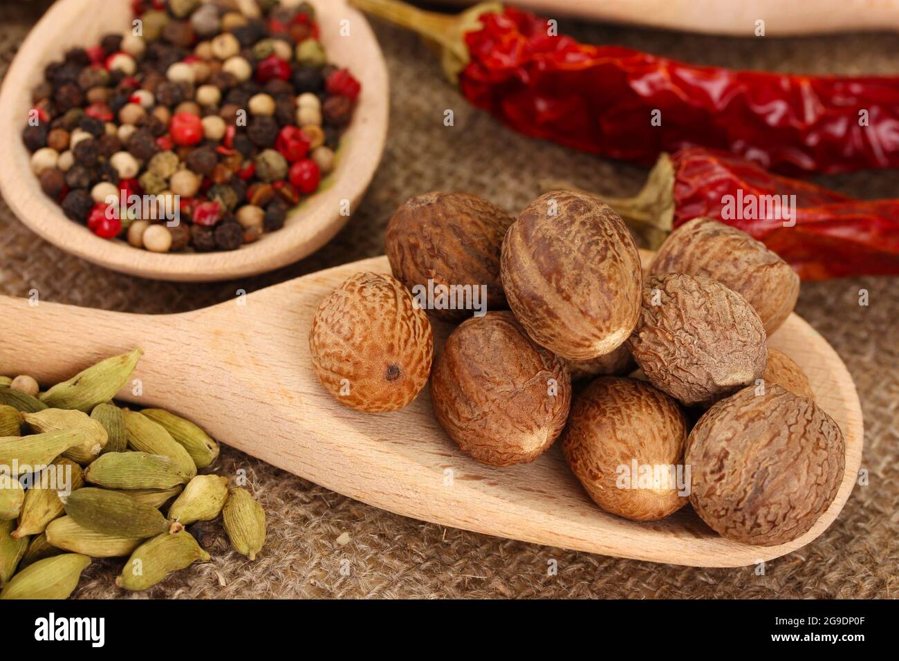 Nutmeg and other spices on sackcloth background Stock Photo Alamy
