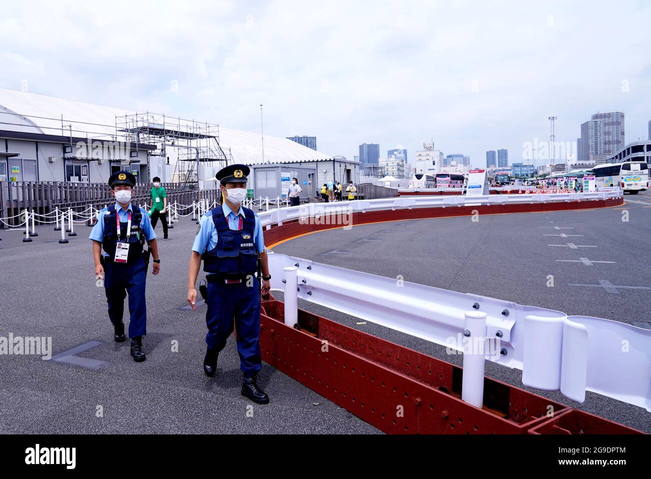Police officers patrol a bus terminal on the third day of the Tokyo 2020 Olympic Games in Japan. Picture date: Monday July 26, 2021. Stock Photo
