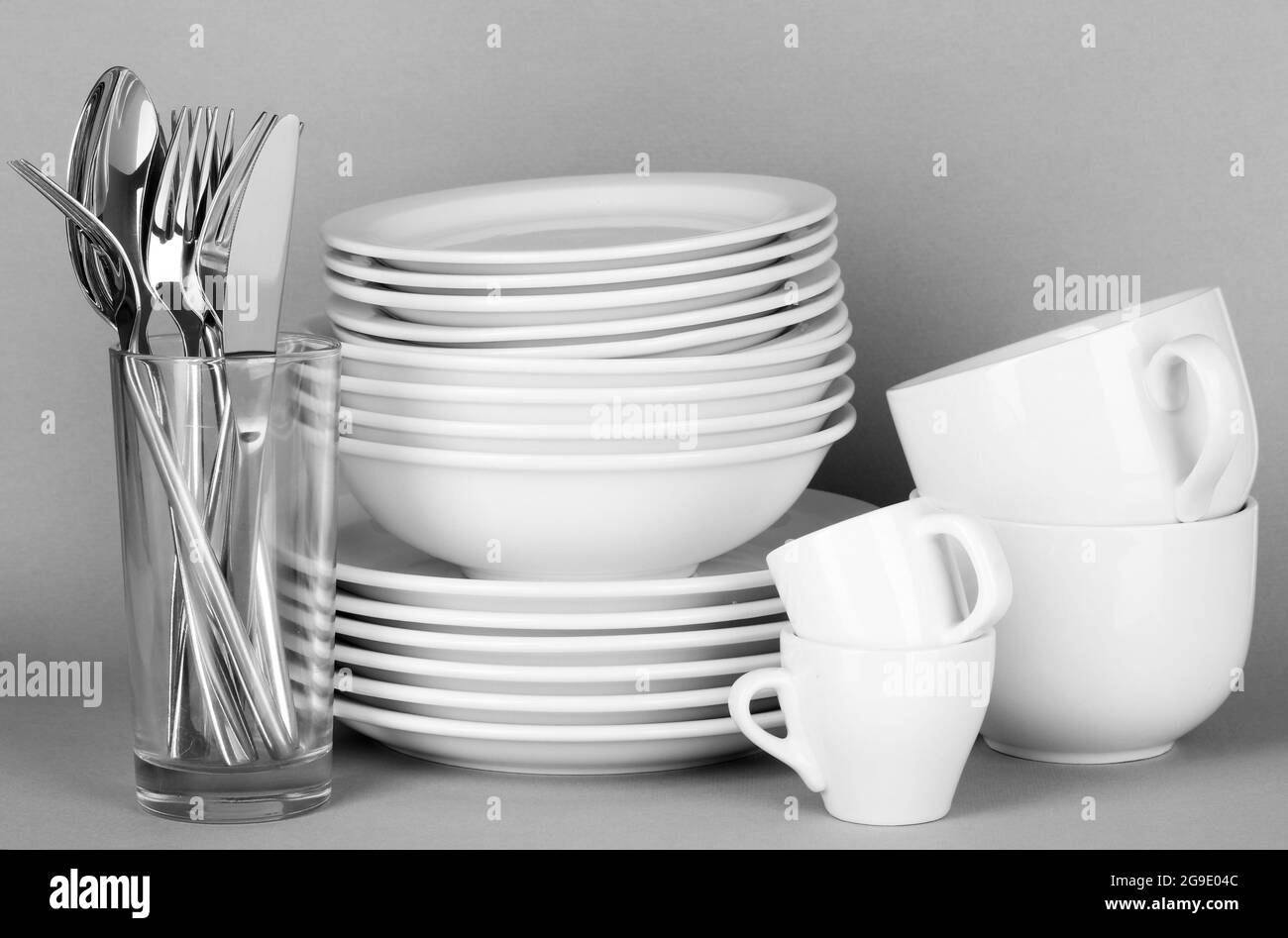 Clean white dishes on grey background Stock Photo Alamy